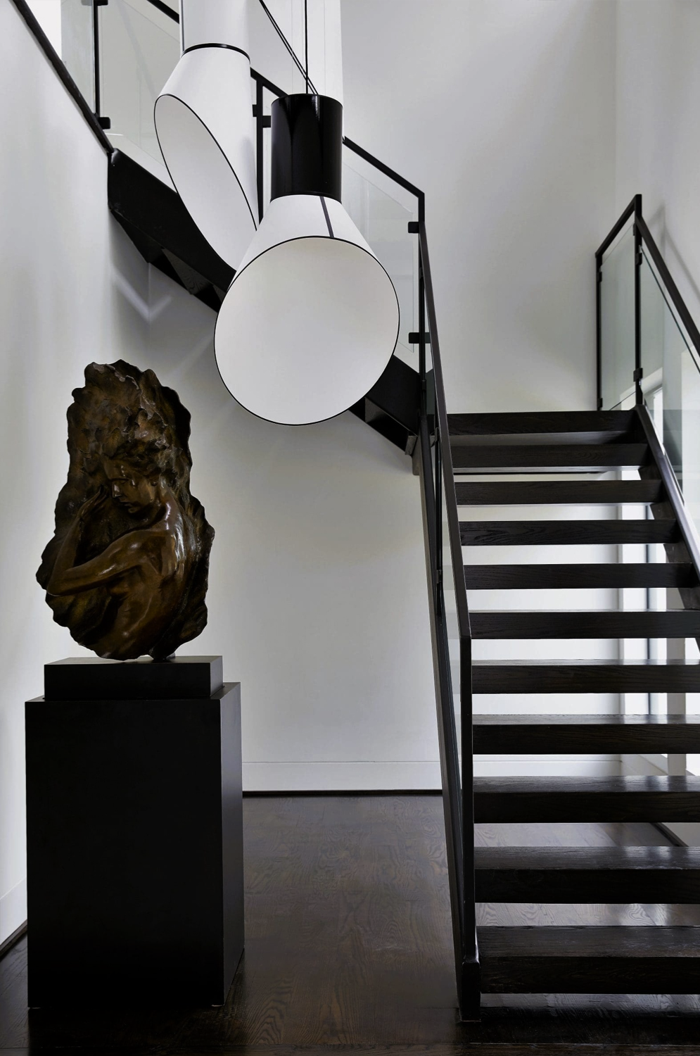 Bunker Hill Village modern staircase interior by Nina Magon Studio with sculptural lighting and art.