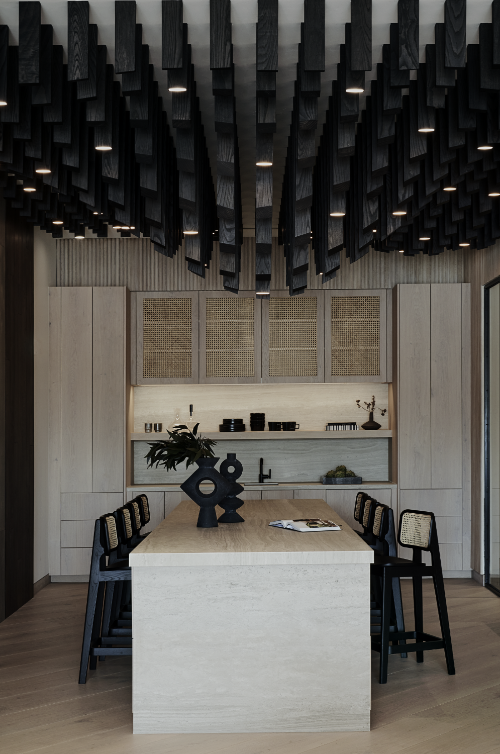 European Floors showroom designed by Nina Magon Studio with oak table, sculptural chairs, and wood slat ceiling.