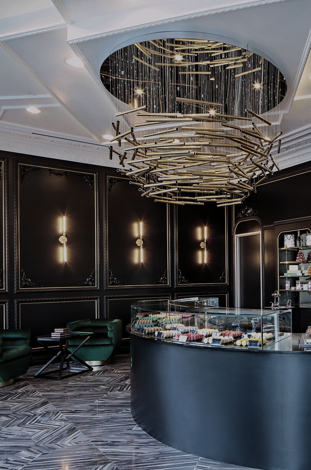 Macaron by Patisse designed by Nina Magon Studio: Parisian boutique with sculptural chandelier, curved glass case, emerald seating.