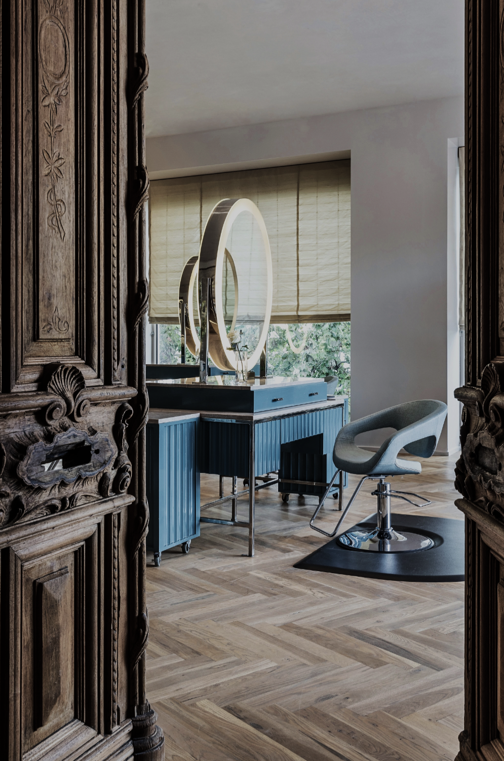 Solaya Spa at The Houstonian by Nina Magon Studio—serene salon with sculptural mirror, blue vanity, forest views.