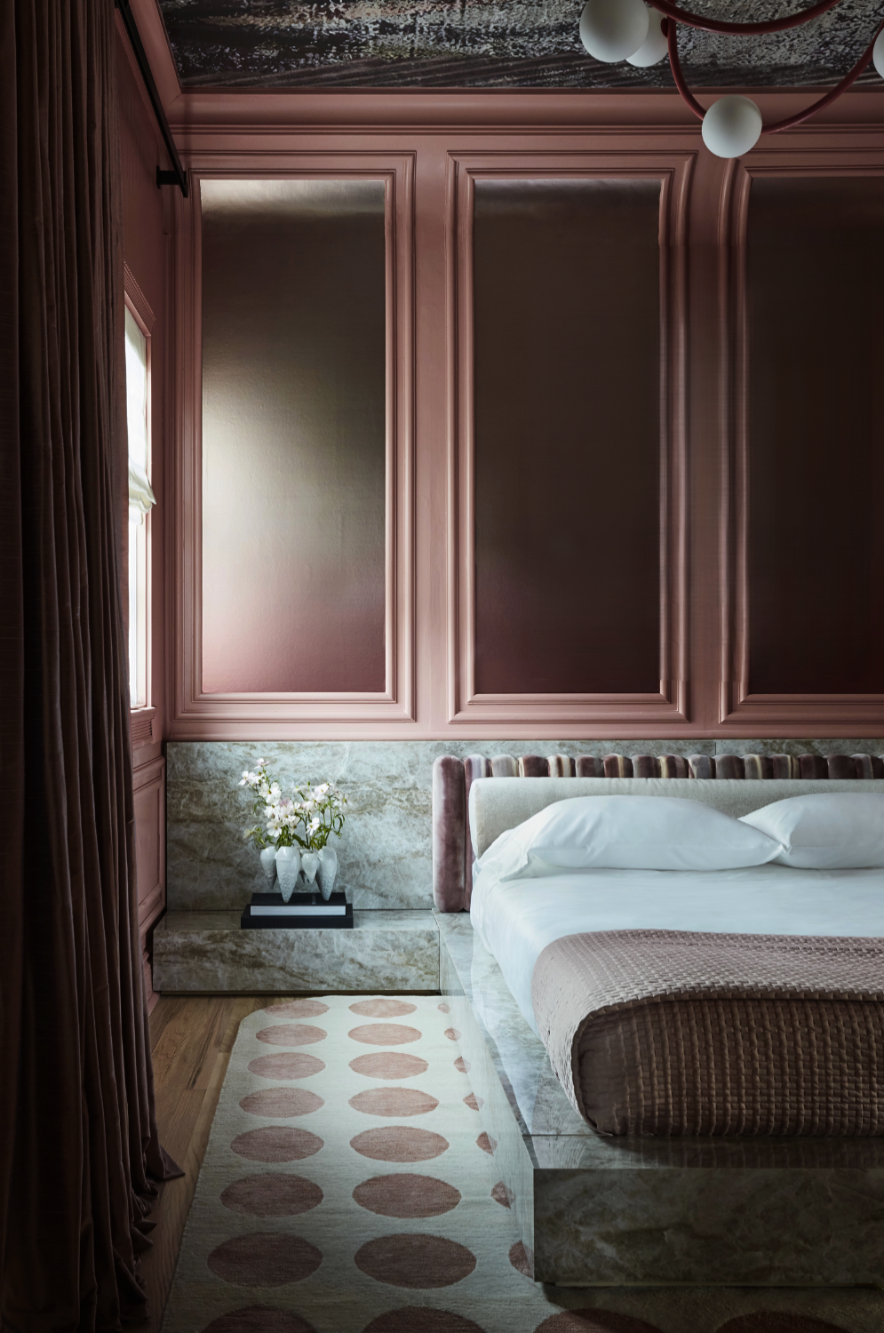 Rose-toned luxury bedroom by Nina Magon Studio featuring a marble platform bed, custom millwork, and soft drapery.